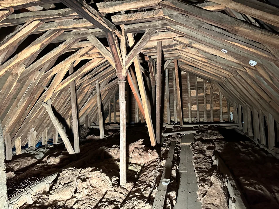 Timber roof structure, bracing and insulation within a loft space.